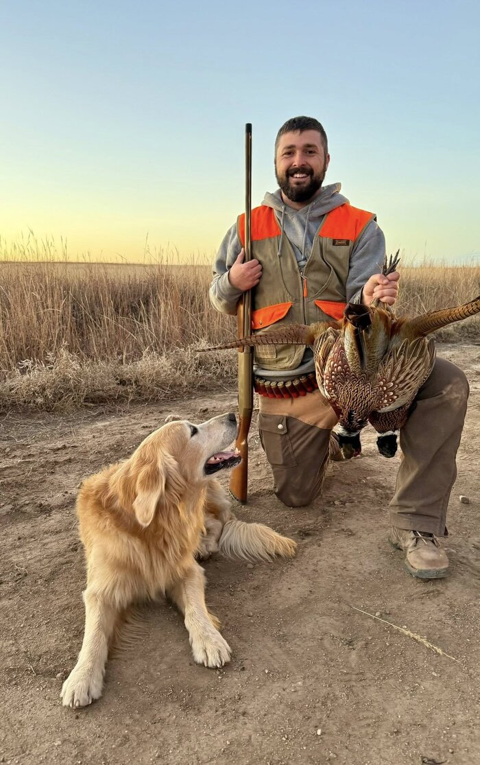 Golden Retriever with hunter and pheasant